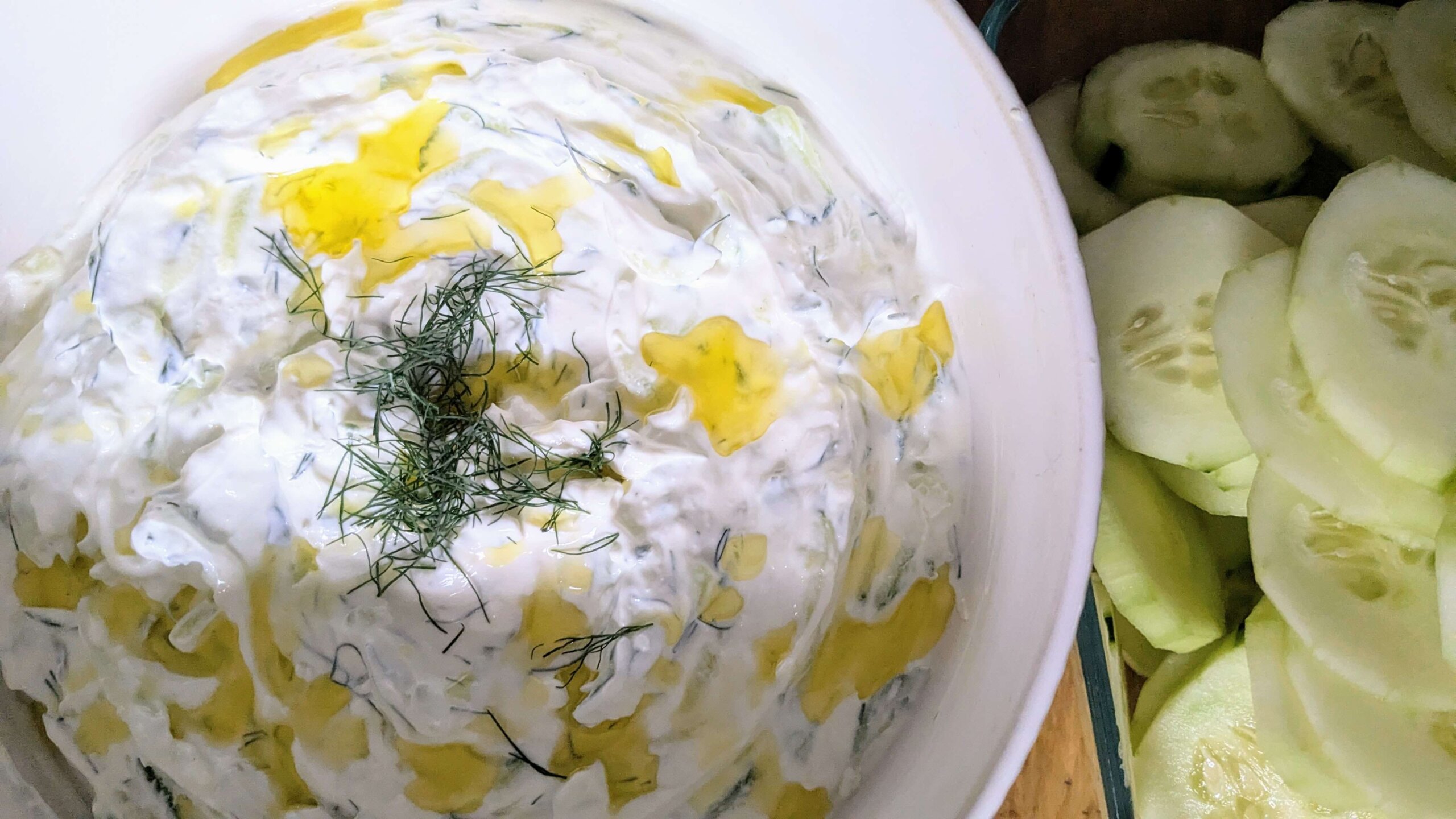 tzatziki sauce topped with olive oil and dill