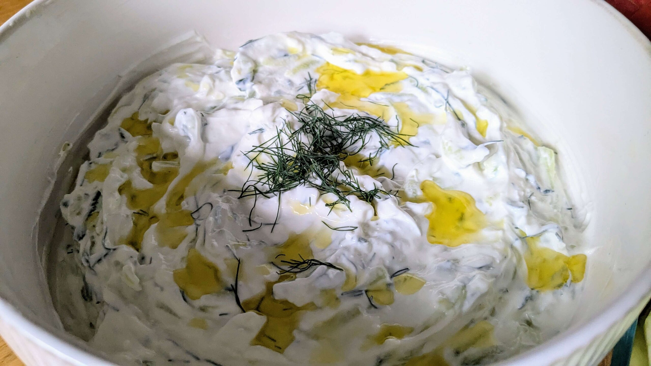 tzatziki sauce topped with olive oil and dill