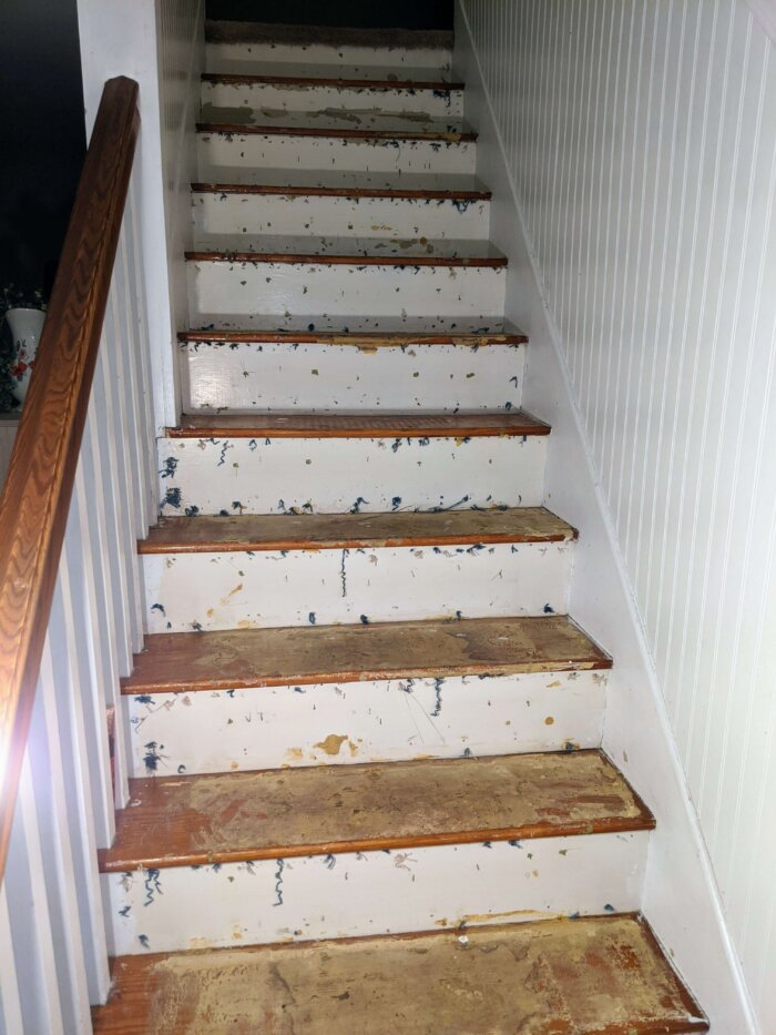 old staircase with nails and staples and glue on treads