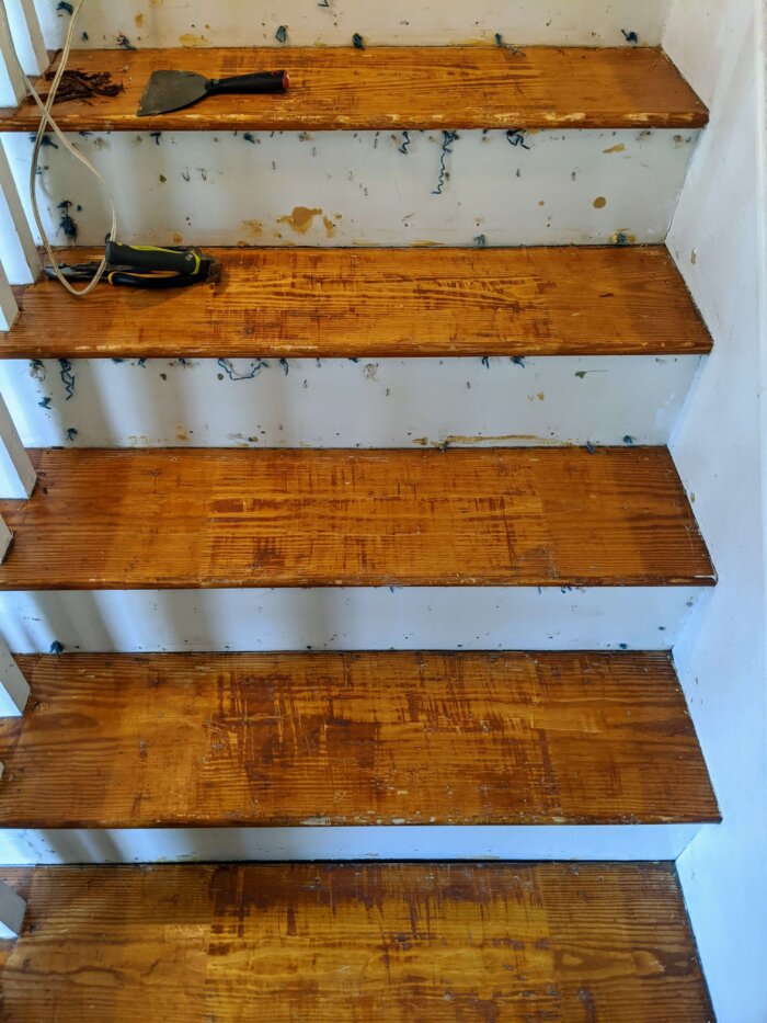 wood staircase with staples being removed