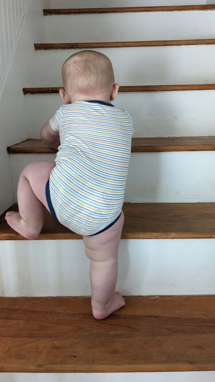 baby climbing refinished stairs