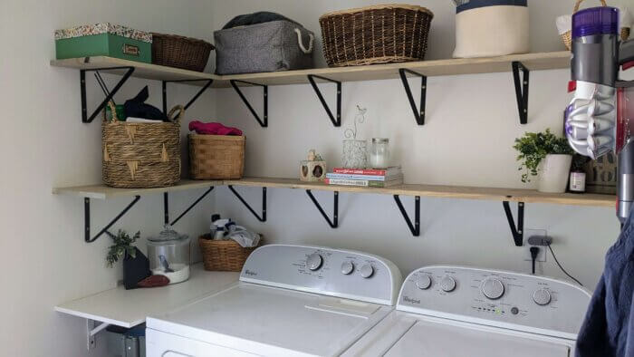 decluttered laundry room with open shelving