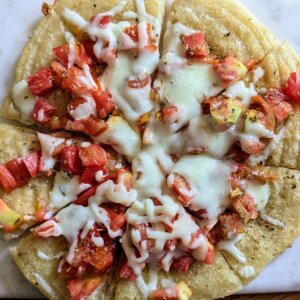 sourdough discard flatbread pizza sliced on a cutting board