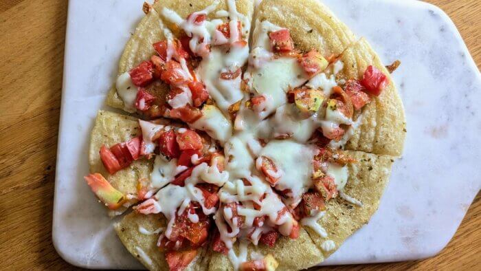 sourdough discard flatbread pizza sliced on a cutting board