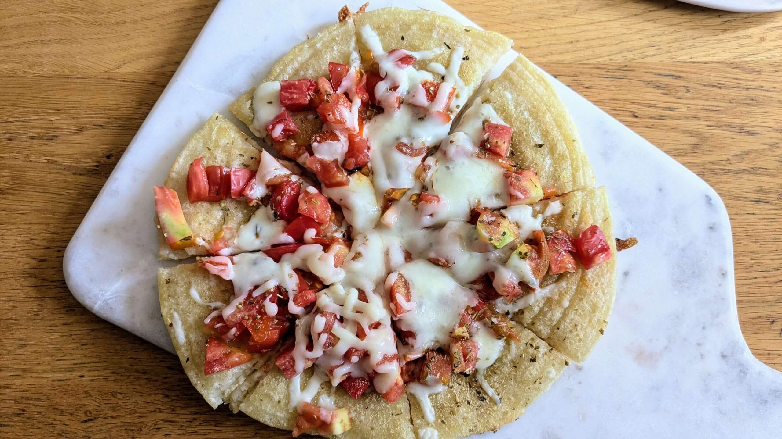 sourdough discard flatbread pizza sliced on a cutting board