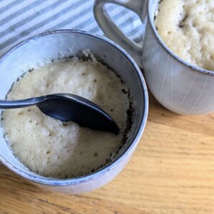 spoon in one of two sourdough chocolate chip mug cakes