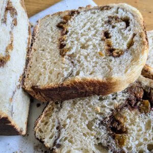 sourdough Cinnamon raisin bread sliced on a cutting board k