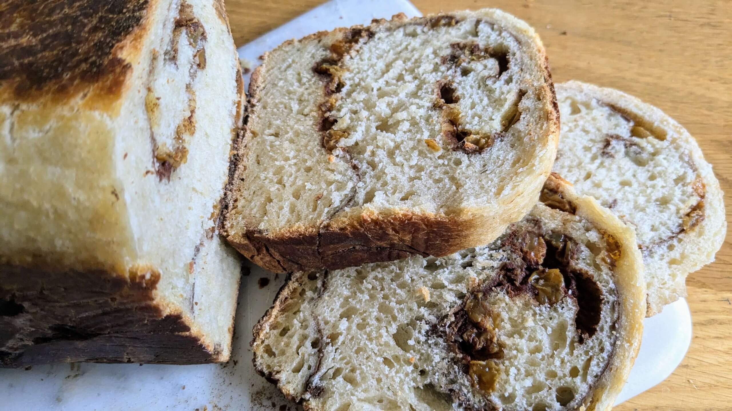 sourdough Cinnamon raisin bread sliced on a cutting board k