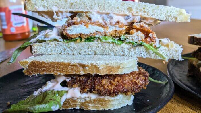 a spicy chicken katsu sandwich cut in half and stacked