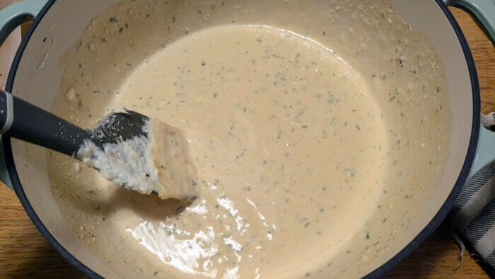 garlic Parmesan cream sauce being stirred