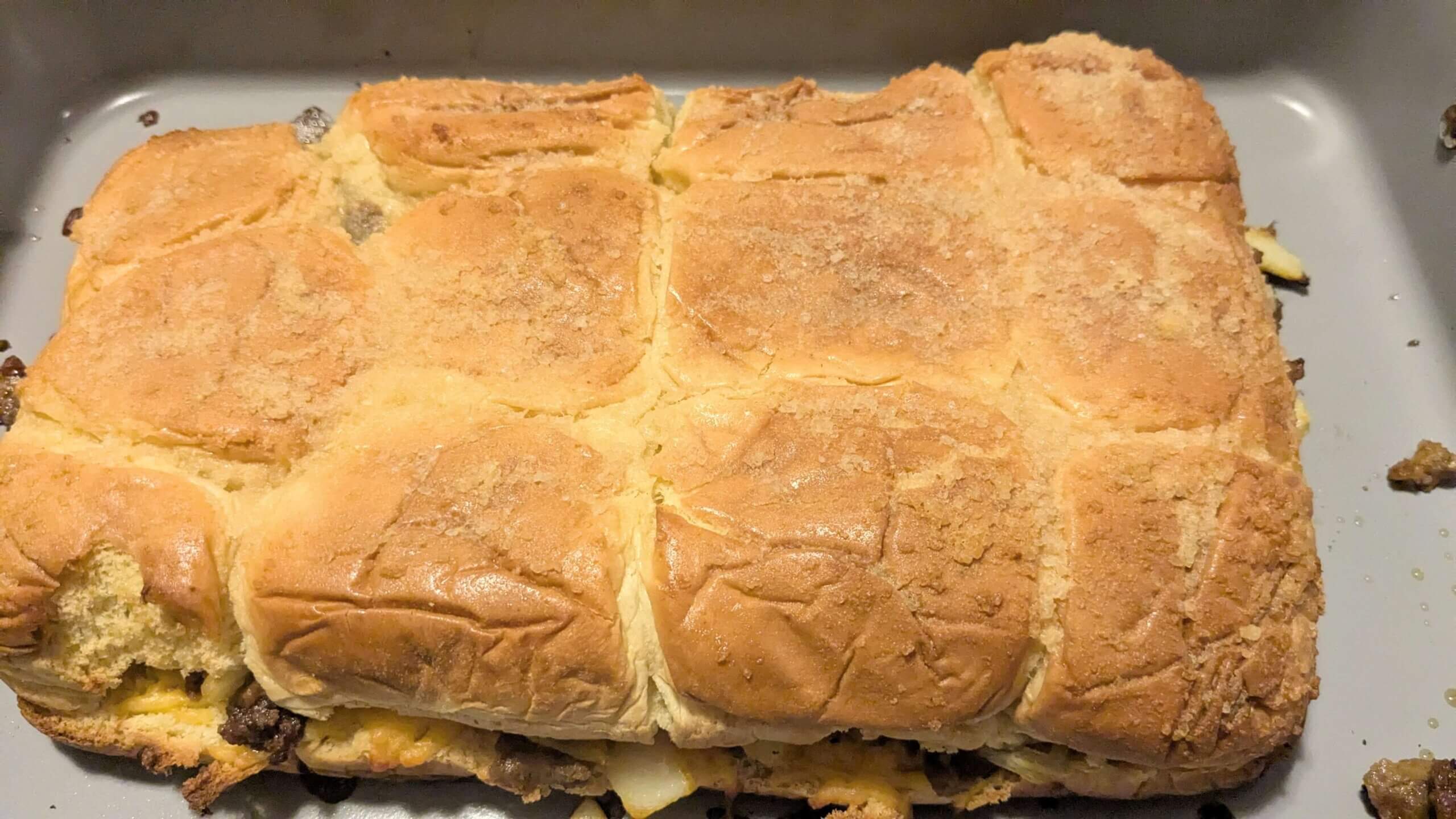cooked Hawaiian Roll Cheeseburger Sliders in a 9x13 Baking pan