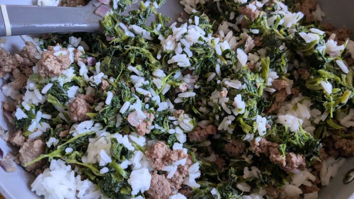 spinach, rice, and ground beef in a skillet