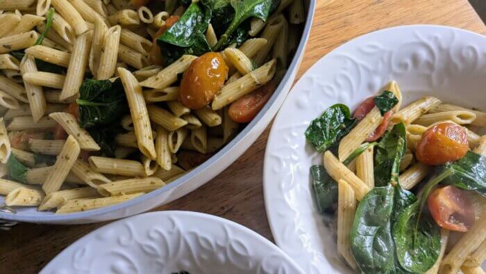 Pesto and Tomato Pasta in a skillet and in two bowls
