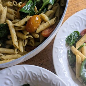 Pesto and Tomato Pasta in a skillet and in two bowls