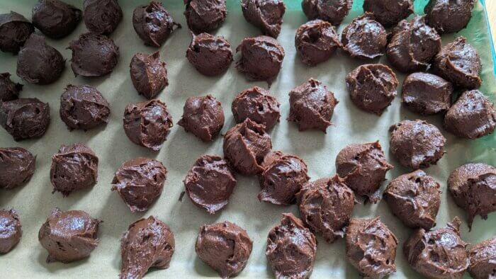 sourdough Brownie cookies dough in balls on a parchment paper lined tray