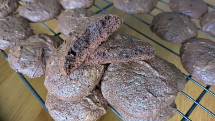 baked sourdough Brownie cookies stacked on a cooling rack