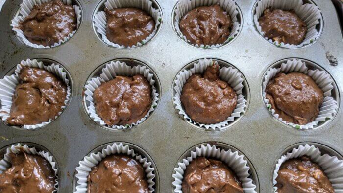 raw muffin batter in muffin tins 