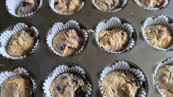 sourdough discard Blueberry muffin raw batter in a muffin tin 