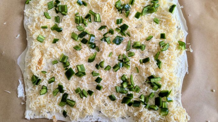 cheese and diced jalapenos on a puffed pastry