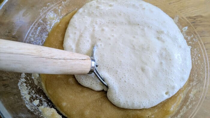 sourdough starter in a batter with a Danish dough whisk 