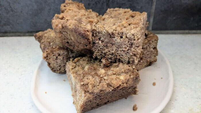 pieces of sourdough coffee cake stacked on each other on a white plate 