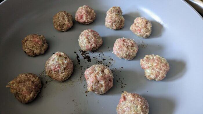 gluten free meatballs sauteing in a pan