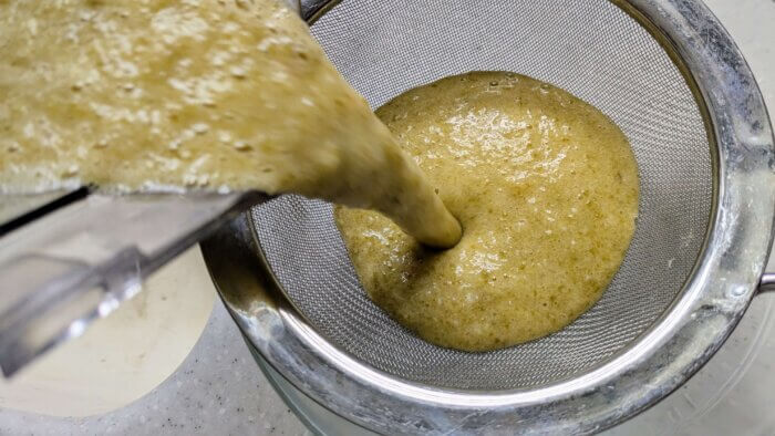 jalapeno Hot sauce recipe being poured through a sieve