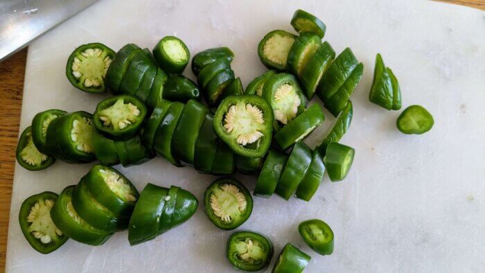 jalapenos sliced on a marble cutting board