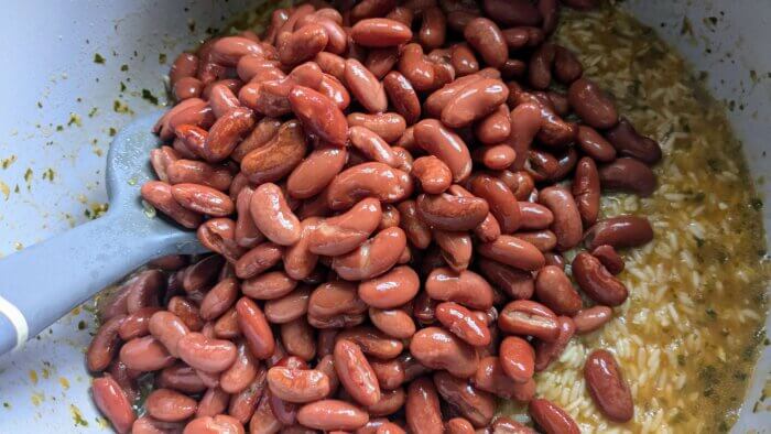 beans in a pot on uncooked rice