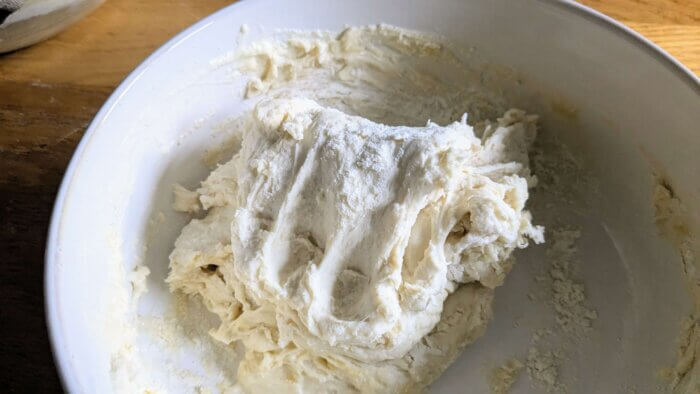 sourdough pizza dough after being kneaded in a bowl