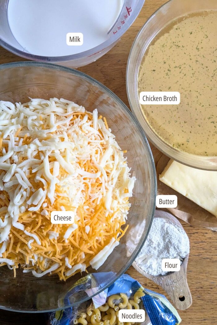 ingredients to make baked Mac and cheese laid out in bowls on a counter 