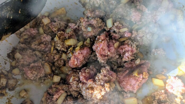 ground beef cooking in spices with onions. 