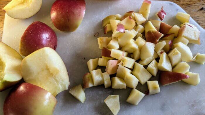 diced apples on a marble cutting board